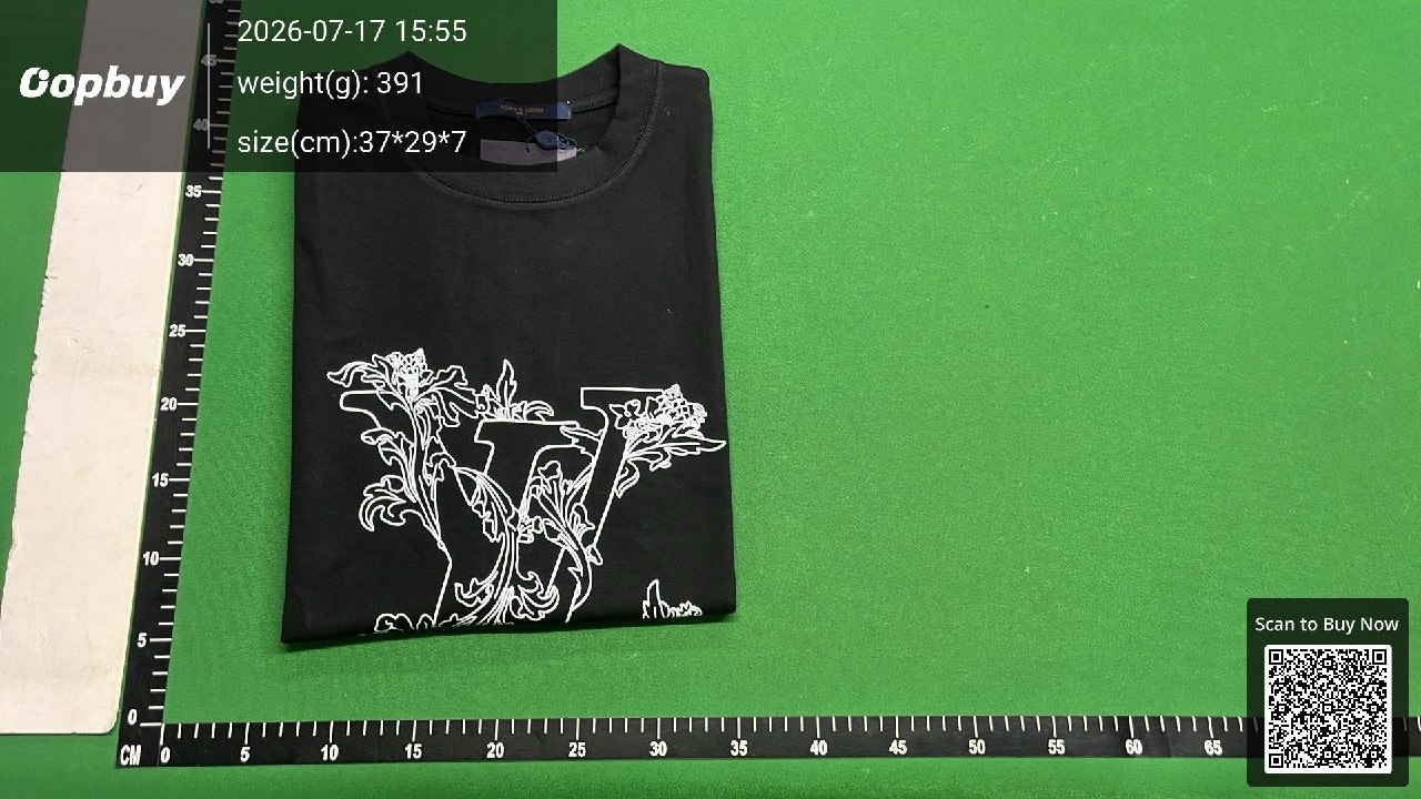 Folded black printed T-shirt on a warehouse mat